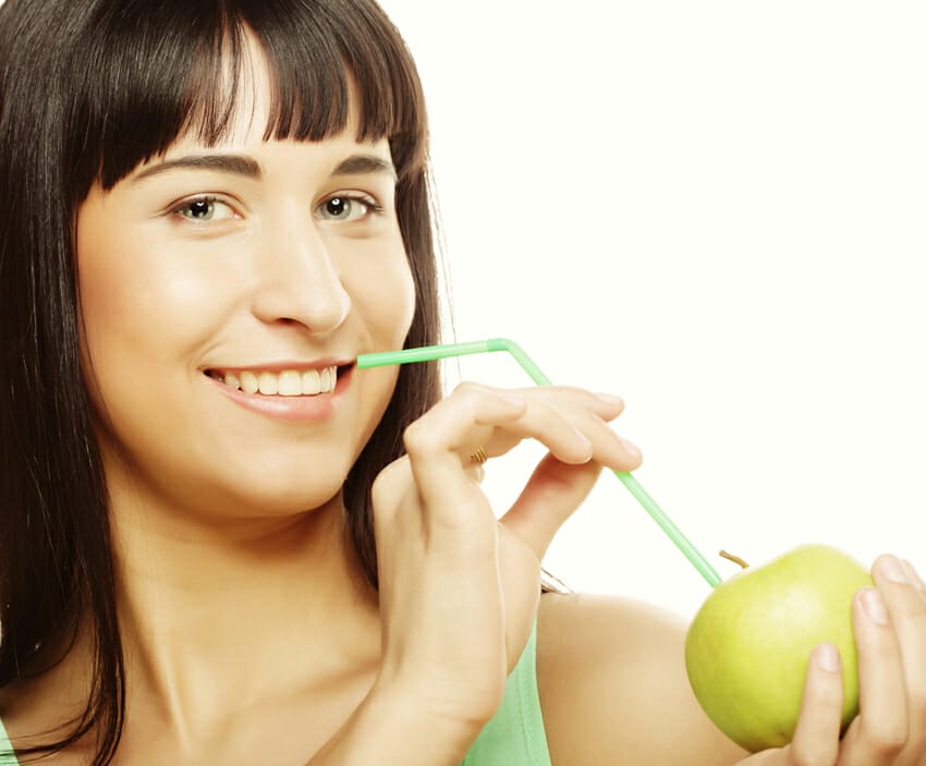 woman with apple and straws